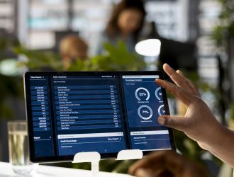 African american business associates reviewing data analytics African american business associates reviewing data analytics and performance metrics in a modern office, creating a new strategy for growth and expansion. Decision making between team members.